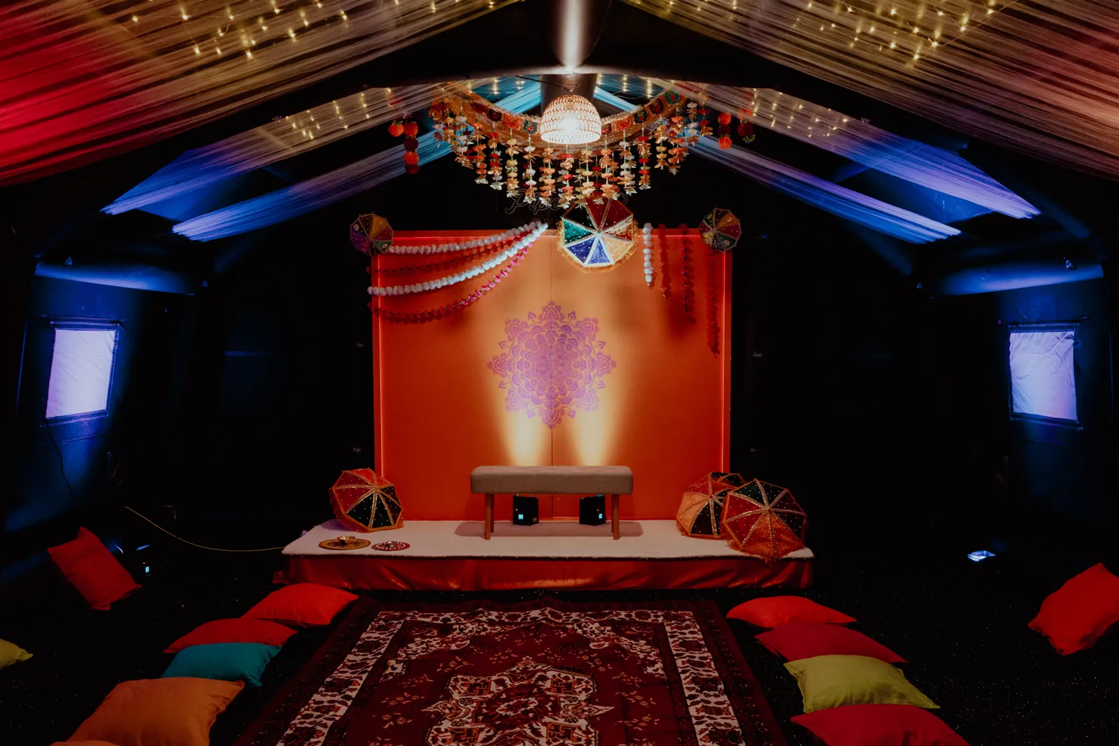 Wide view of the Suite styled for a mehndi with rug and floor cushions